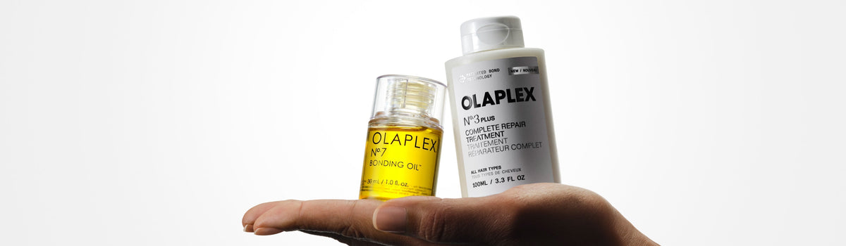 OLAPLEX Nº.3PLUS and Nº.7 Bonding Oil being held in the palm of an outstretched hand