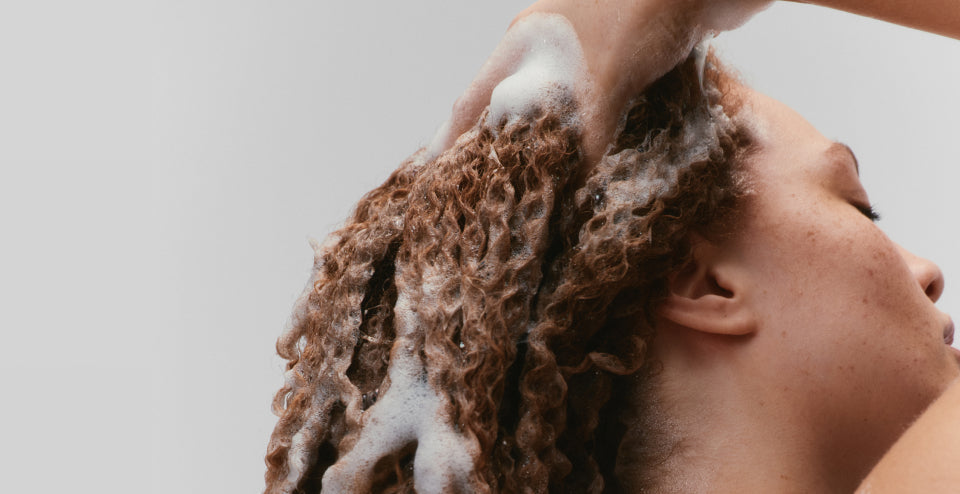 woman washing curly hair with No.4CURL Shampoo