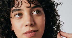 Curly-haired woman feeling her hair