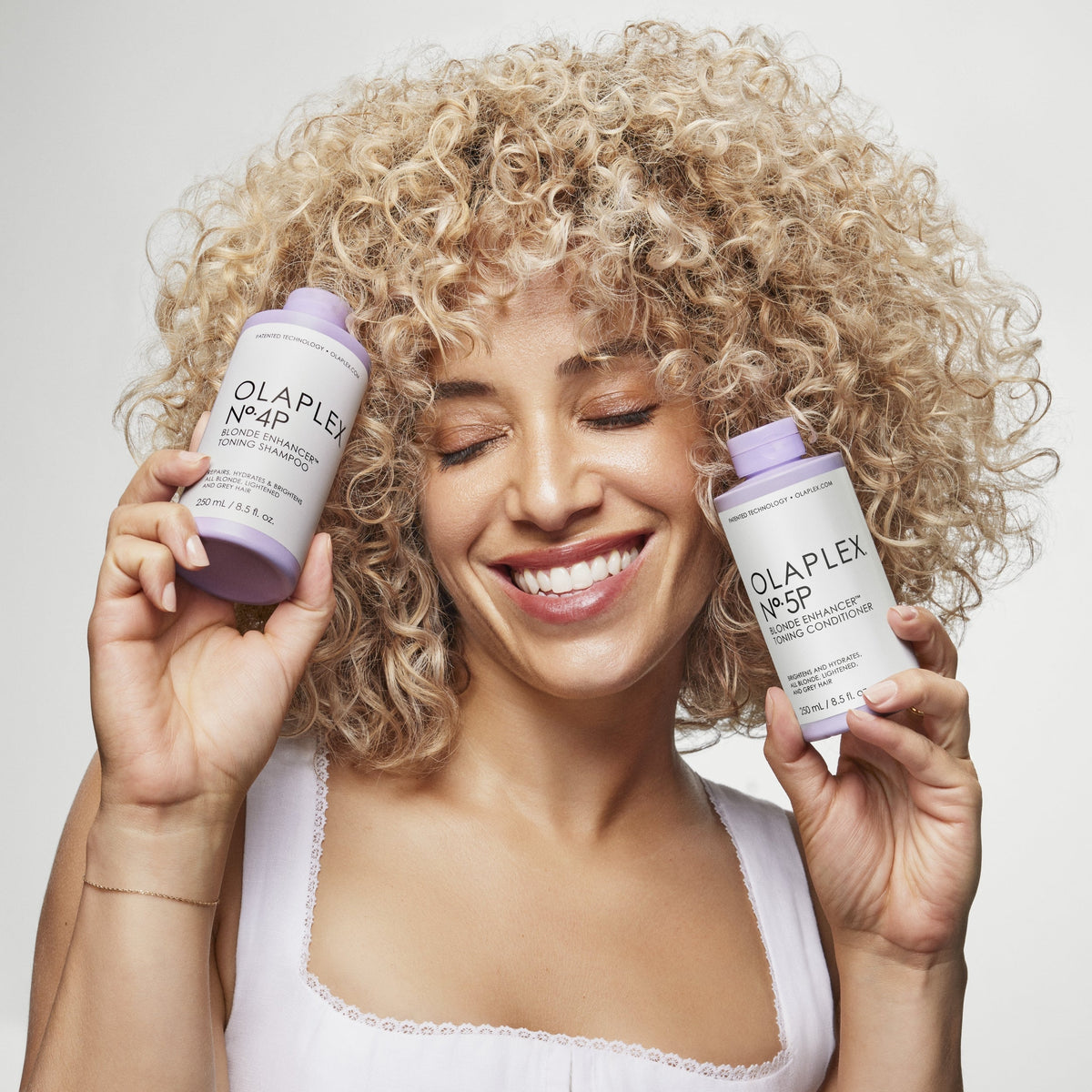 Woman with blonde curly hair holding No.4P and No.5P