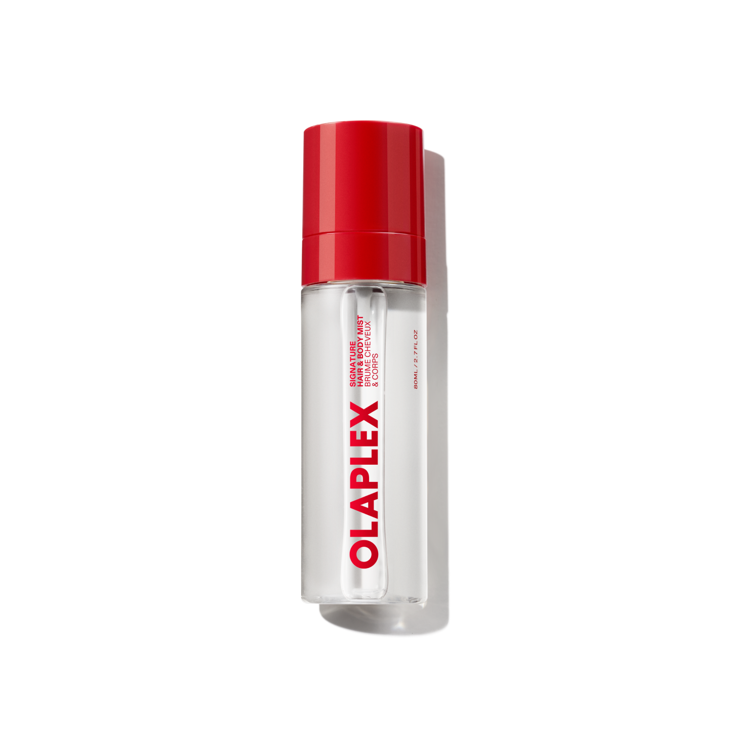 A clear bottle of Olaplex Hair and Body Fragrance Mist featuring a vibrant red cap and the bold Olaplex logo printed vertically down the front, shown against a transparent grid background.