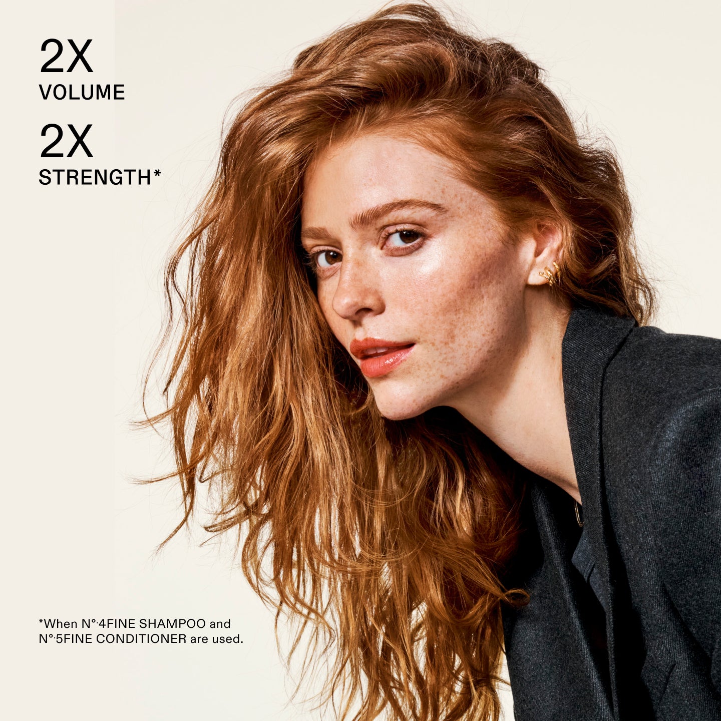 Woman with voluminous hair against a beige background, highlighting 2 times volume, 2 times strength by using No.4FINE & No.5 FINE