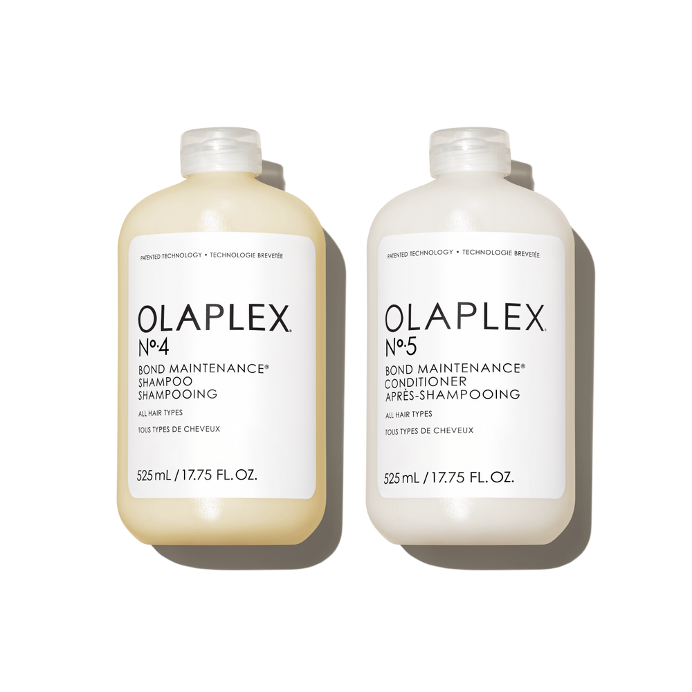 Two Jumbo (525ml) bottles of OLAPLEX N°.4 Bond Maintenance Shampoo and N°.5 Bond Maintenance Conditioner on a transparent background. Each bottle is 525 mL / 17.75 fl. oz. and features clean, minimalist black text branding. - main view